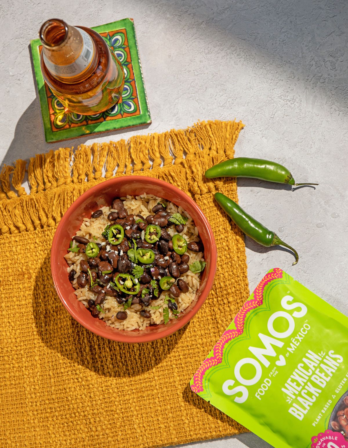 SOMOS rice and black bean bowl styled with jalapeños