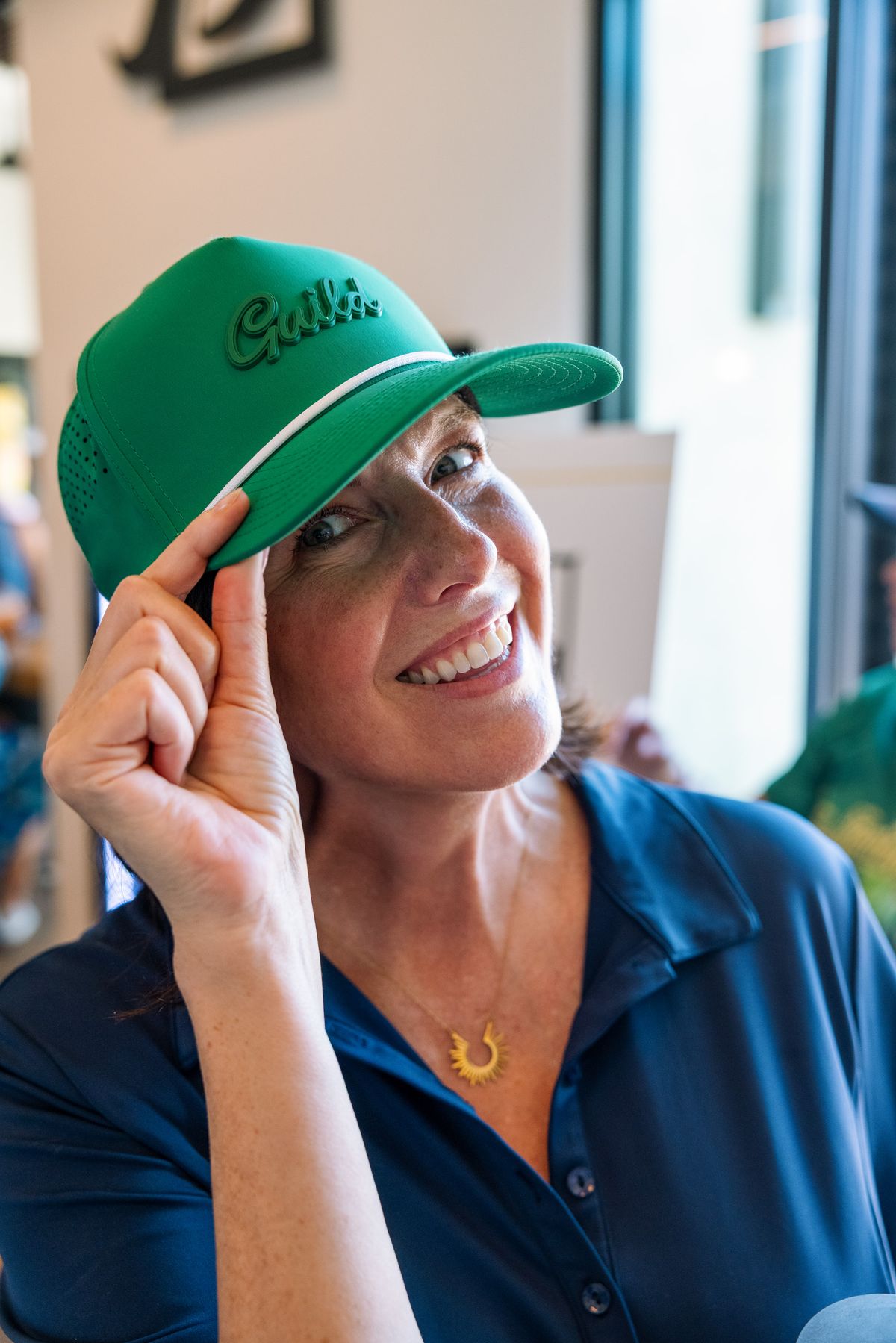Guest tipping her Guild cap at the golf invitational
