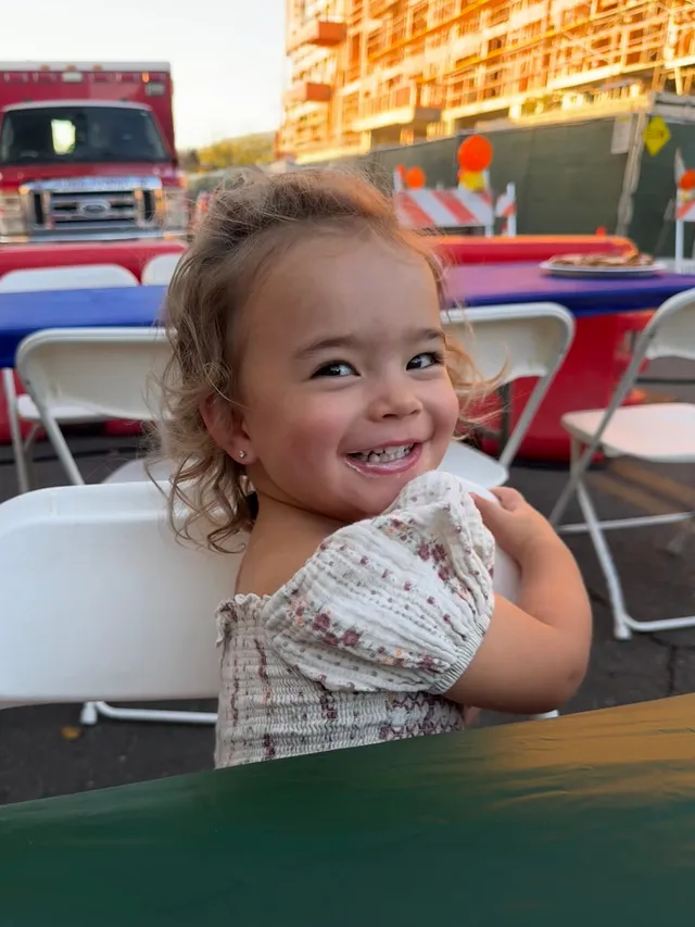 A little girl smiling at the camera
